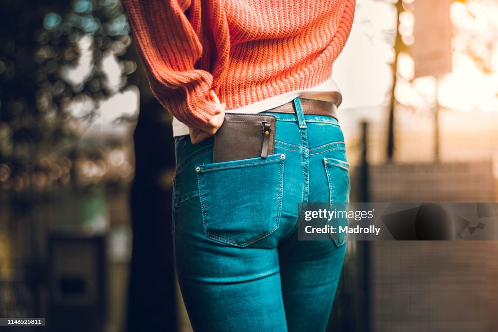 Closeup shot from behind of woman in jeans with wallet in the pocket