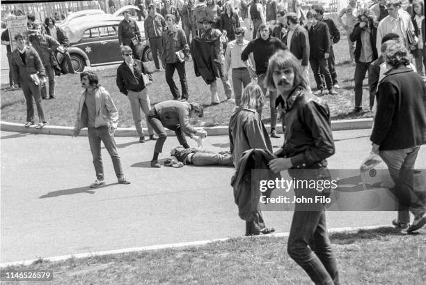 View of Kent State University students around the body of student Jeffrey Miller after he'd been shot when the Ohio National Guard opened fire on...