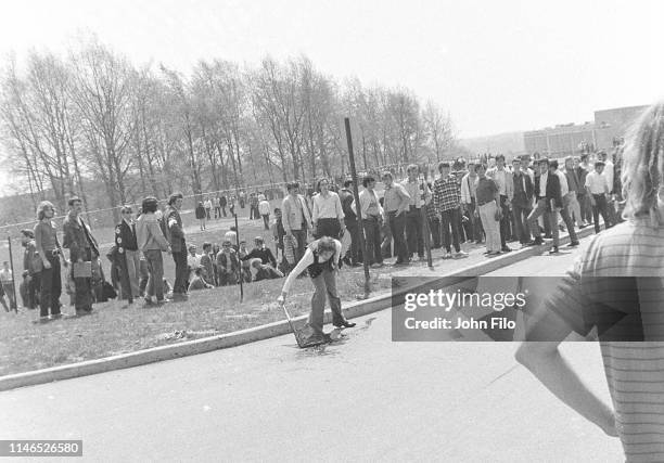 An unidentified Kent State University student drags a black flag in Jeffrey Miller's blood after the Ohio National Guard opened fire on antiwar...