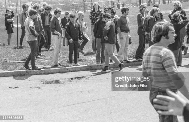 Kent State University students look at Jeffrey Miller's blood on the ground after the Ohio National Guard opened fire on antiwar protesters at Kent...
