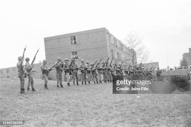 View of a line of armed Ohio National Guardsmen as they stand at the top of Blanket Hill, facing the Commons, on the Kent State University campus,...