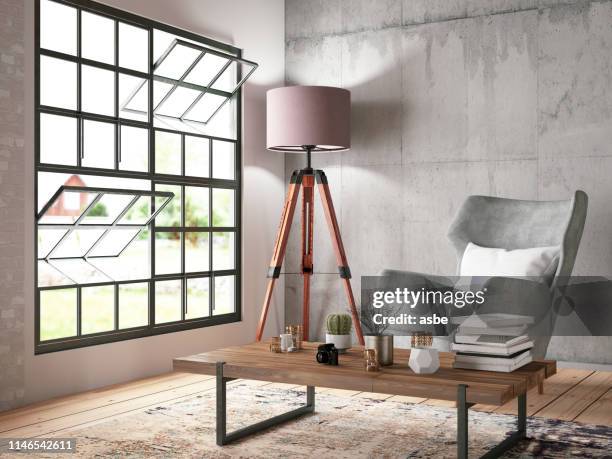 interieur mit sessel und büchern - couchtisch stock-fotos und bilder