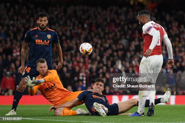 Alexandre Lacazette of Arsenal has his shot blocked by Norberto Murara Neto and Gabriel Paulista of Valencia during the UEFA Europa League Semi Final...