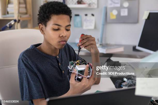 teen boy enjoys robotics kit at home - disassembled stock pictures, royalty-free photos & images