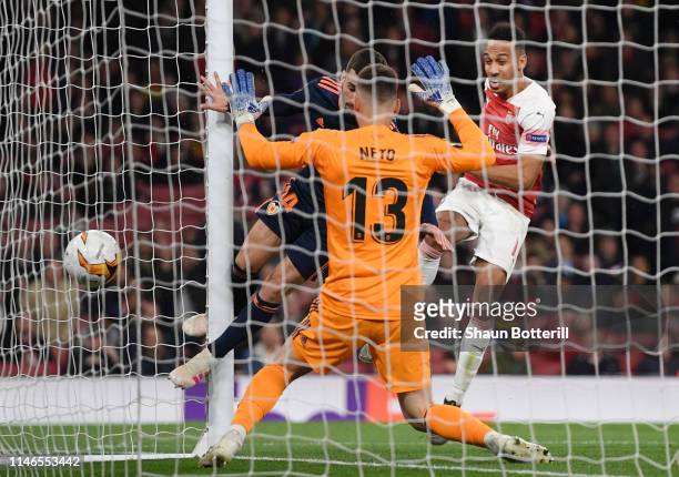 Pierre-Emerick Aubameyang of Arsenal scores his team's third goal past Jose Luis Gaya and Norberto Murara Neto of Valencia during the UEFA Europa...