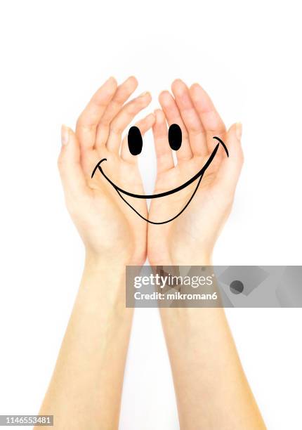 hand holding out with a smile - thumb emoji stock pictures, royalty-free photos & images