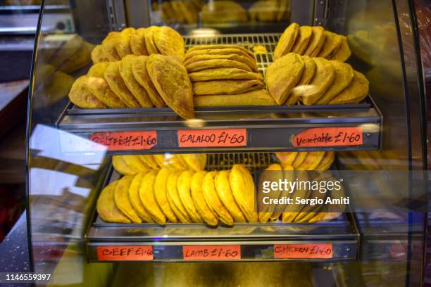 jamaican patties on sale in a shop - jamaican culture stock-fotos und bilder