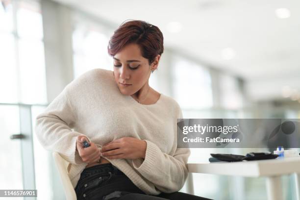 diabetic woman uses insulin pen - diabetes lifestyle stock pictures, royalty-free photos & images