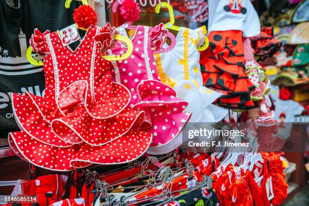 gypsy costumes typical of seville, hung in gift shop - seville fair stock pictures, royalty-free photos & images