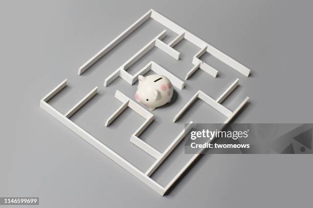 financial planning concept image. - piggy bank and maze stock pictures, royalty-free photos & images