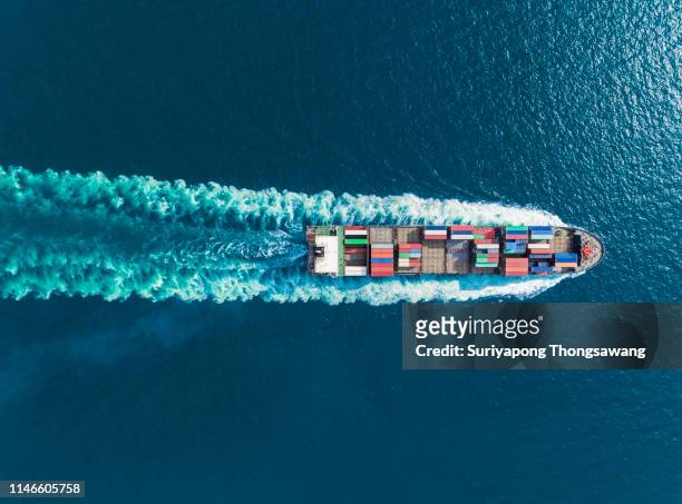 aerial top view container ship full speed with beautiful wave pattern for logistics, import export, shipping or transportation. - container ship fotografías e imágenes de stock