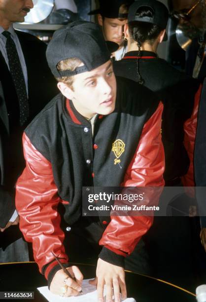 Singer-songwriter Joey McIntyre of New Kids On The Block signing a legal document, circa 1990.