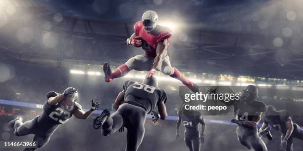 eroe del football americano che salta sugli avversari durante la partita allo stadium - placcare foto e immagini stock