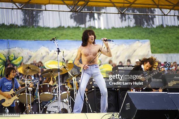 Malcholm Young, Bon Scott and Angus Young playing with 'AC/DC' performing at Oakland Coliseum in Oakland, California on July 21, 1979.