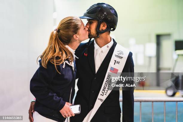 Nayel Nassar of Egypt kisses his girlfriend Jennifer Gates of USA after the Longines Grand Prix de New York, at the Longines Masters New York 2019,...