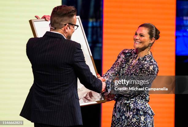 Crown Princess Victoria of Sweden presents Bart Moeyaert with his prize during a ceremony for the presentation of the 2019 Astrid Lindgren Memorial...