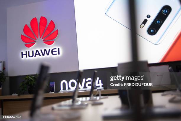 In this photo taken on May 27 a Huawei logo is displayed at a retail store in Beijing. - China is digging in for a tough period of deteriorating ties...