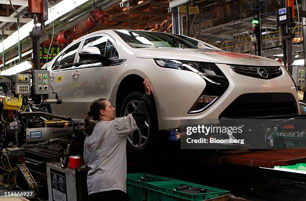 Dawn Bacon works on a General Motors Co. 2012 Opel Ampera, GM's European version of the Volt, at Detroit-Hamtramck Assembly Plant in Detroit,...