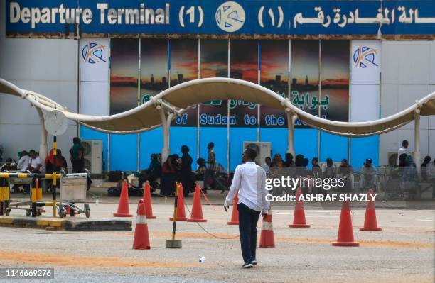 Passengers wait outside the departure terminal at Khartoum airport on May 28, 2019 as aviation professionals take part in a two-day national strike...