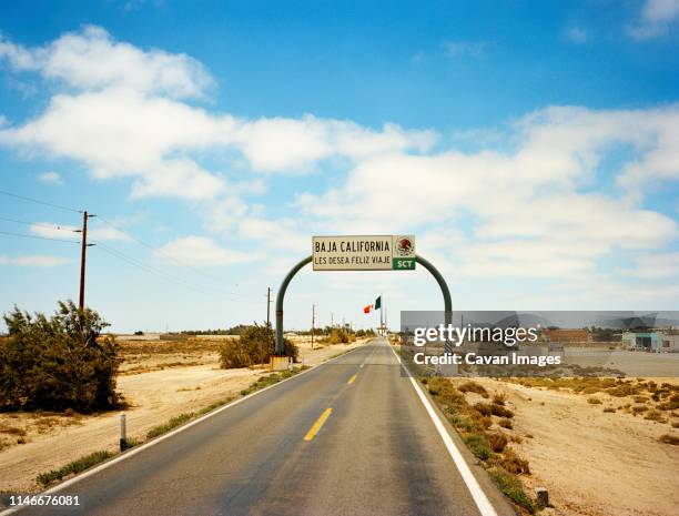 a baja california sign headed south through the baja peninsuila. - baja california peninsula stock pictures, royalty-free photos & images