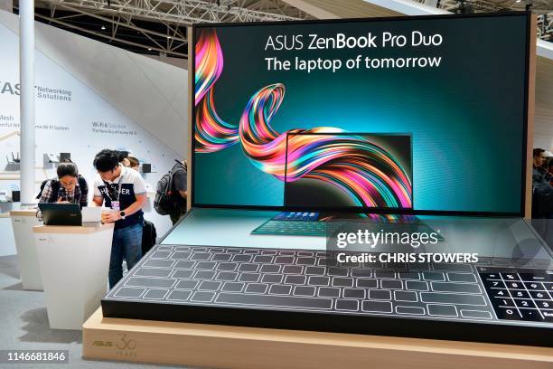 People visit the ASUS stand during Computex at Nangang exhibition centre in Taipei on May 28, 2019.