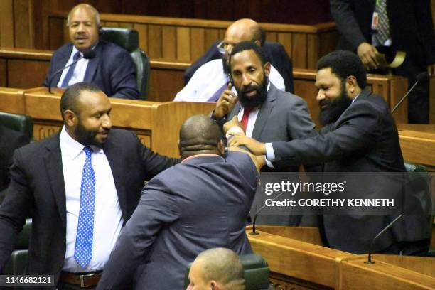 Members of the parliament react during the session in Port Moresby on May 28, 2019. - Papua New Guinea Prime Minister Peter O'Neill stalled his...