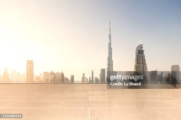 empty platform with city skyline and cityscape at sunset in dubai.uae - dubai aerial stock pictures, royalty-free photos & images