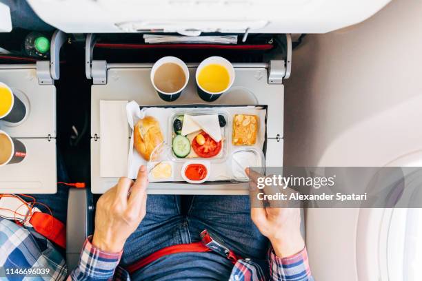 eating airplane food during a flight, personal perspective directly above view - ekonomiklass bildbanksfoton och bilder