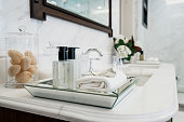 beautiful amenity hotel set on white marble counter in bathroomm