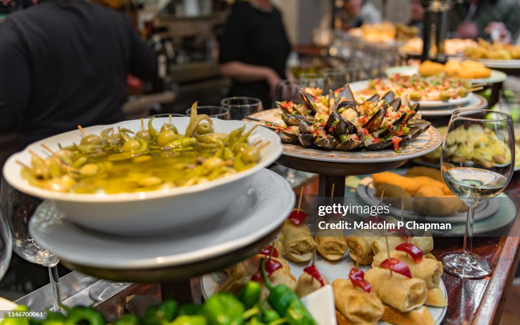 Typical Pintxos, tapas, on a bar counter in San Sebastian, Donostia, Basque region, Spain.
