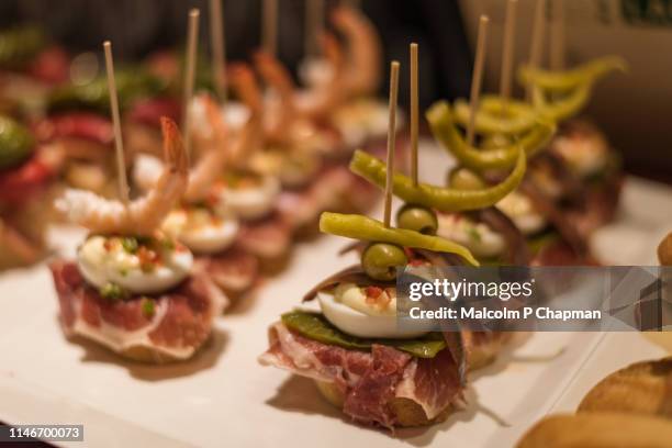 typical pintxos, tapas, iberia ham with egg and anchovy or prawn, served in san sebastian, donostia, basque region, spain. - pinchos stock-fotos und bilder