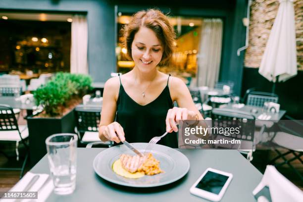 woman enjoying dinner in gourmet restaurant - tuna seafood imagens e fotografias de stock