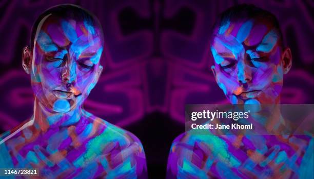 portrait of beautiful woman with fluorescent make up in ulteaviolet light - body painting woman imagens e fotografias de stock