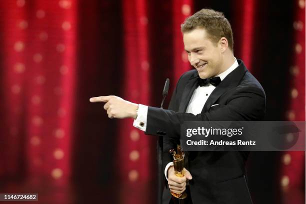 Alexander Fehling, winner best male supporting role, reacts on stage during the Lola - German Film Award show at Palais am Funkturm on May 03, 2019...