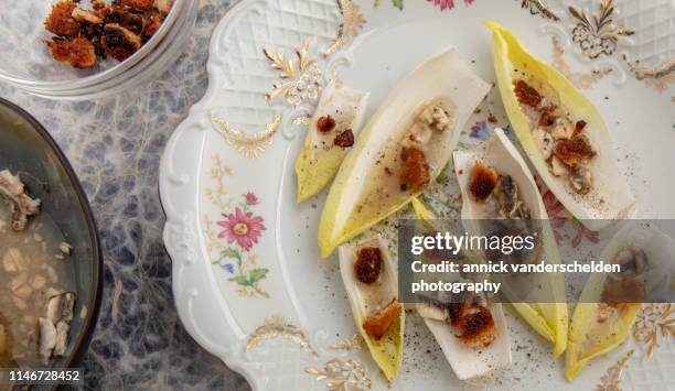 preparation endive salad with anchovy dressing - witloof chicory stock pictures, royalty-free photos & images