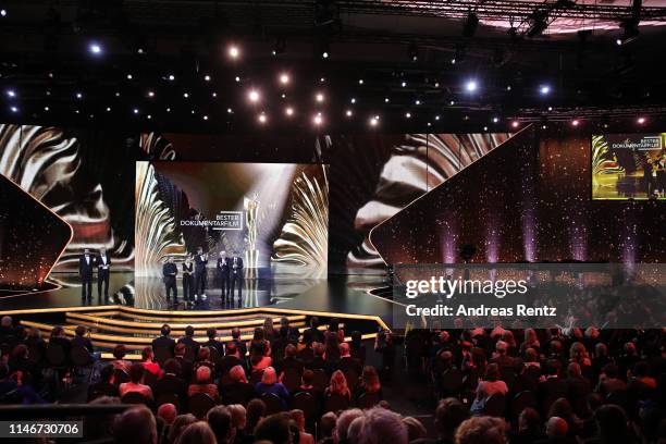 The team of the best documentary award winners are seen on stage during the Lola - German Film Award show at Palais am Funkturm on May 03, 2019 in...