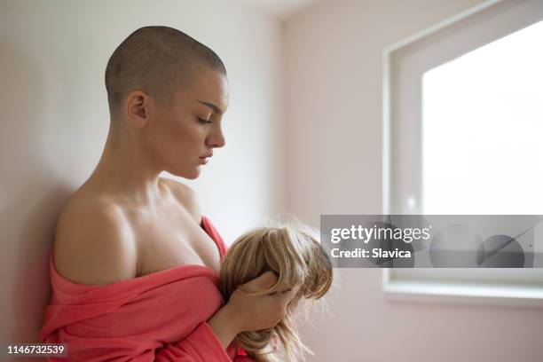 woman suffering from cancer holding wig - peruca imagens e fotografias de stock