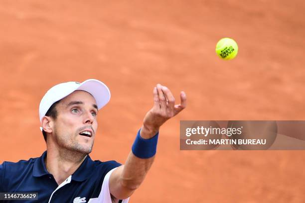 Spain's Roberto Bautista Agut serves the ball to Steve Johnson of the US during their men's singles first round match on day three of The Roland...