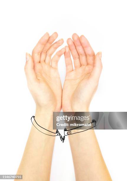 hand holding out palm straight handcuffed - prison escape stock pictures, royalty-free photos & images