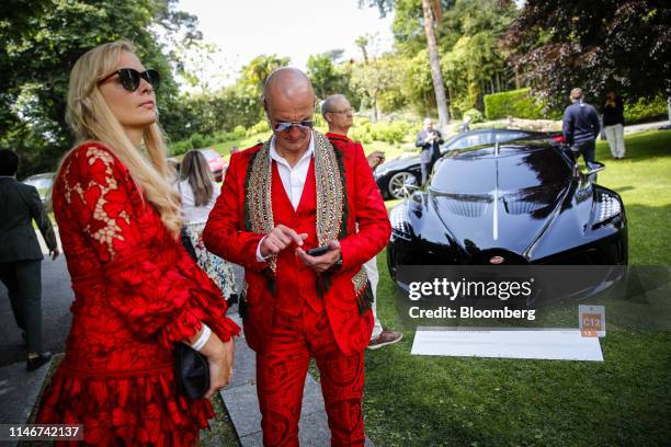 Attendees stand next to a Bugatti Automobiles SAS La Voiture Noire ultra luxury automobile during the 2019 Concorso d'Eleganza Villa d'Este show in...