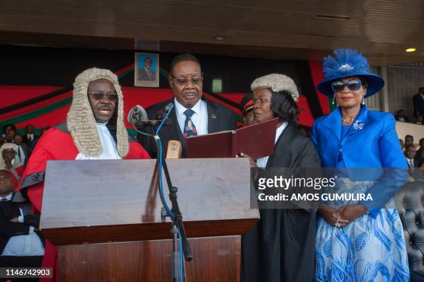 Malawi's President elect Arthur Peter Mutharika is sworn in for his second term by Chief Justice Andrew Nyirenda and Registrar of the high Court and...