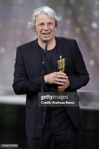 Andreas Dresen, winner of best directing, reacts on stage during the Lola - German Film Award show at Palais am Funkturm on May 03, 2019 in Berlin,...
