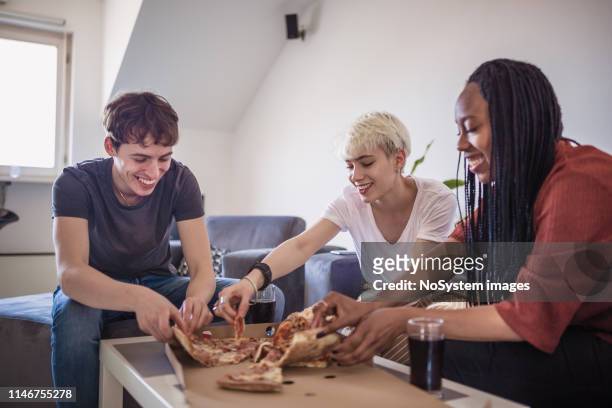 generation z roommates eating pizza - sharing pizza stock pictures, royalty-free photos & images
