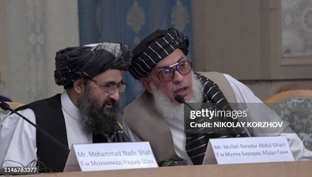 This AFPTV screen grab from a video made on May 28, 2019 in Moscow shows Mullah Abdul Ghani Baradar and Stanikzai Sher Mohammad Abbas Abbas, Afghan...