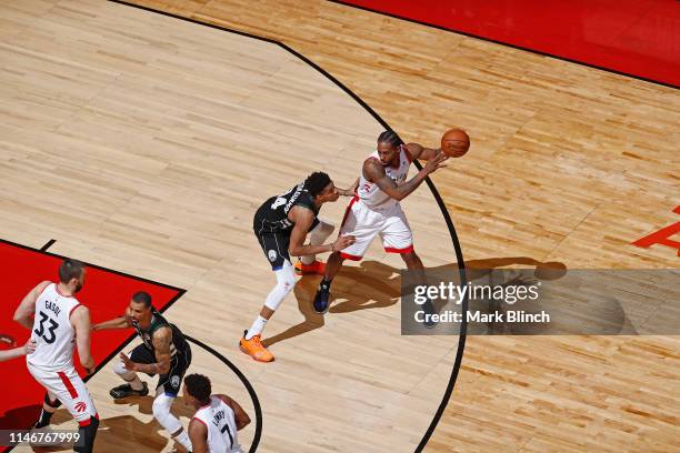 Kawhi Leonard of the Toronto Raptors handles the ball against Giannis Antetokounmpo of the Milwaukee Bucks during Game Six of the Eastern Conference...