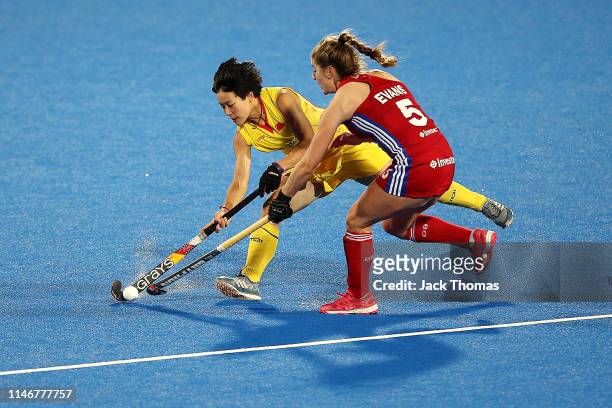 Jiangzin He of China is challenged by Sarah Evans of Great Britain during the Women's FIH Field Hockey Pro League match between Great Britain and...