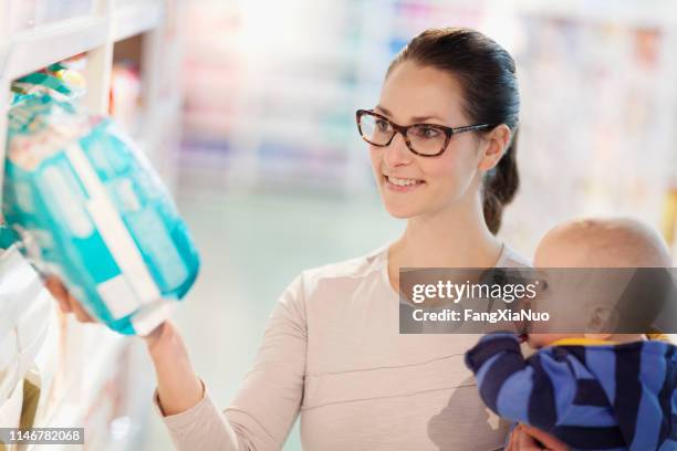 einzelmutter und baby-einkauf im supermarkt - babyausrüstung stock-fotos und bilder