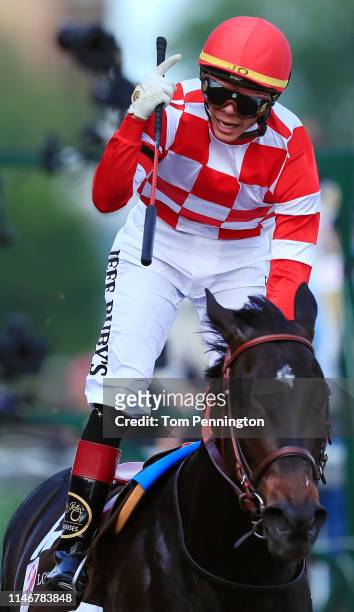 Jockey Jose Ortiz celebrates aboard Serengeti Empress after crossing the finish line to win the 145th running of the Kentucky Oaks at Churchill Downs...