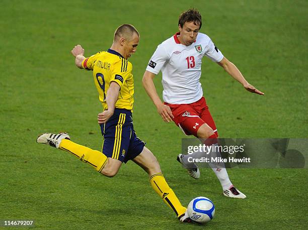 Kenny Miller of Scotland shoots under pressure from Christopher Gunter of Wales during the Carling Nations Cup match between Wales and Scotland at...