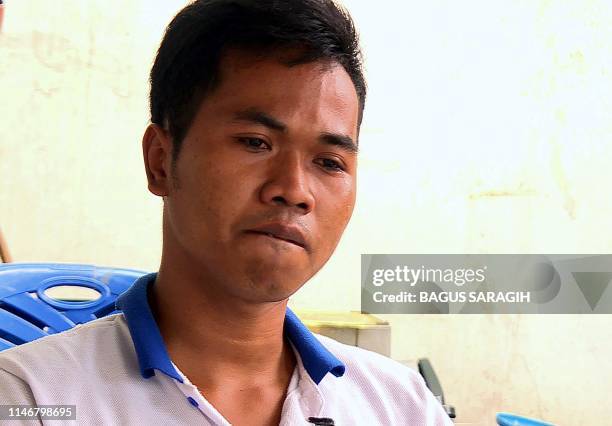 This framegrab taken from AFPTV shows Indonesian fisherman Rahmatullah talking during an interview in Jakarta on February 21, 2019. - Enslaved,...